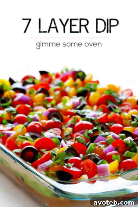 A wide shot of the freshly prepared 7 Layer Dip on a table, ready for a game day party.