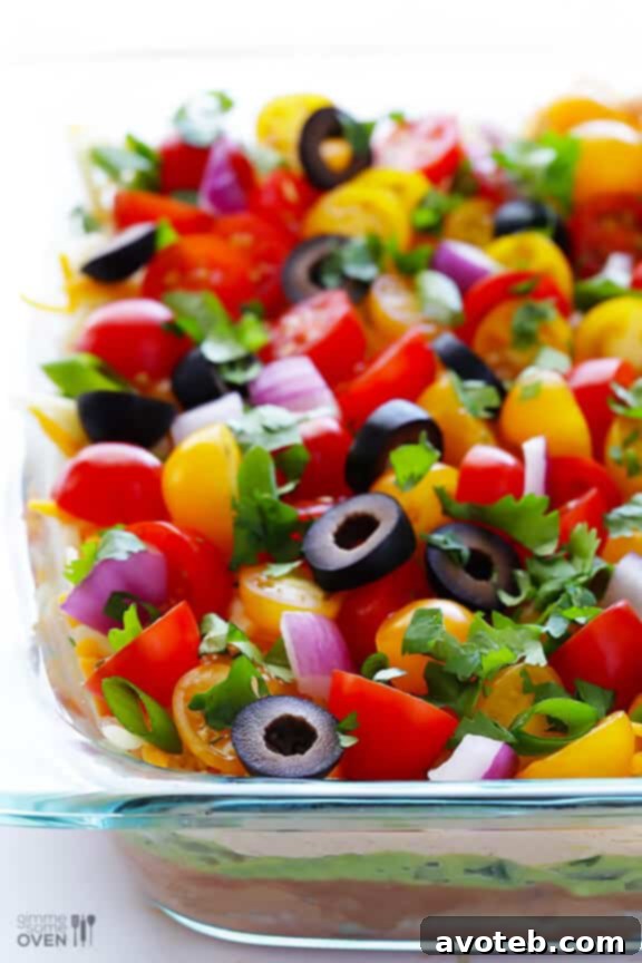 Preparing a 7 Layer Dip: Spreading the ingredients evenly in a shallow dish for optimal enjoyment.