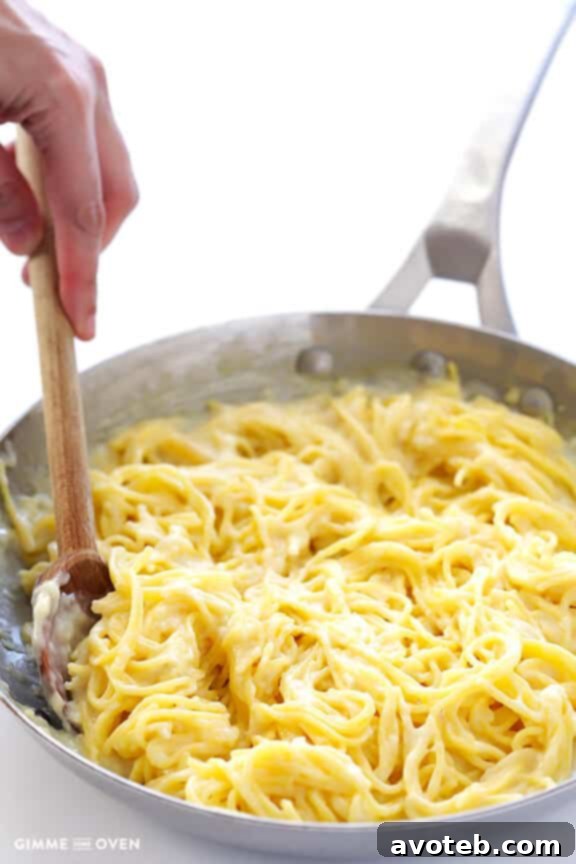Mixing Gluten-Free Alfredo Sauce with pasta as you eat it -- a perfect creamy, quick, and healthy meal. | gimmesomeoven.com #glutenfree #gf