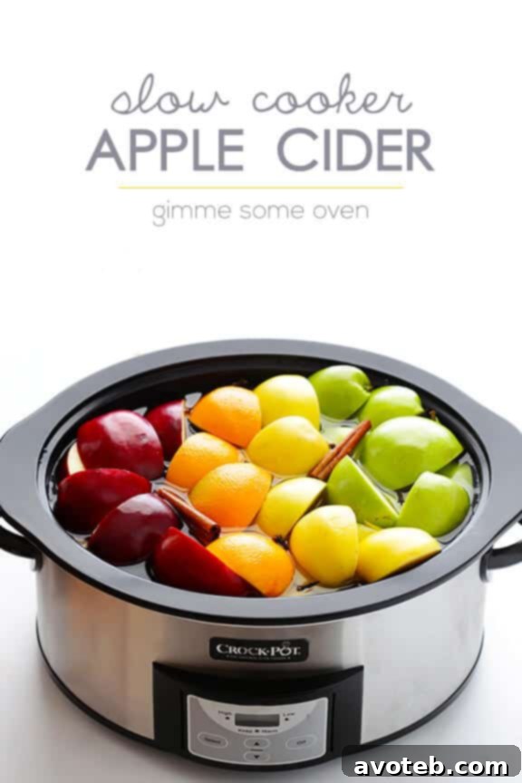 A close-up view of a slow cooker, generously filled with freshly made apple cider, exuding warmth and inviting aromas, poised and ready to be served to eager guests.