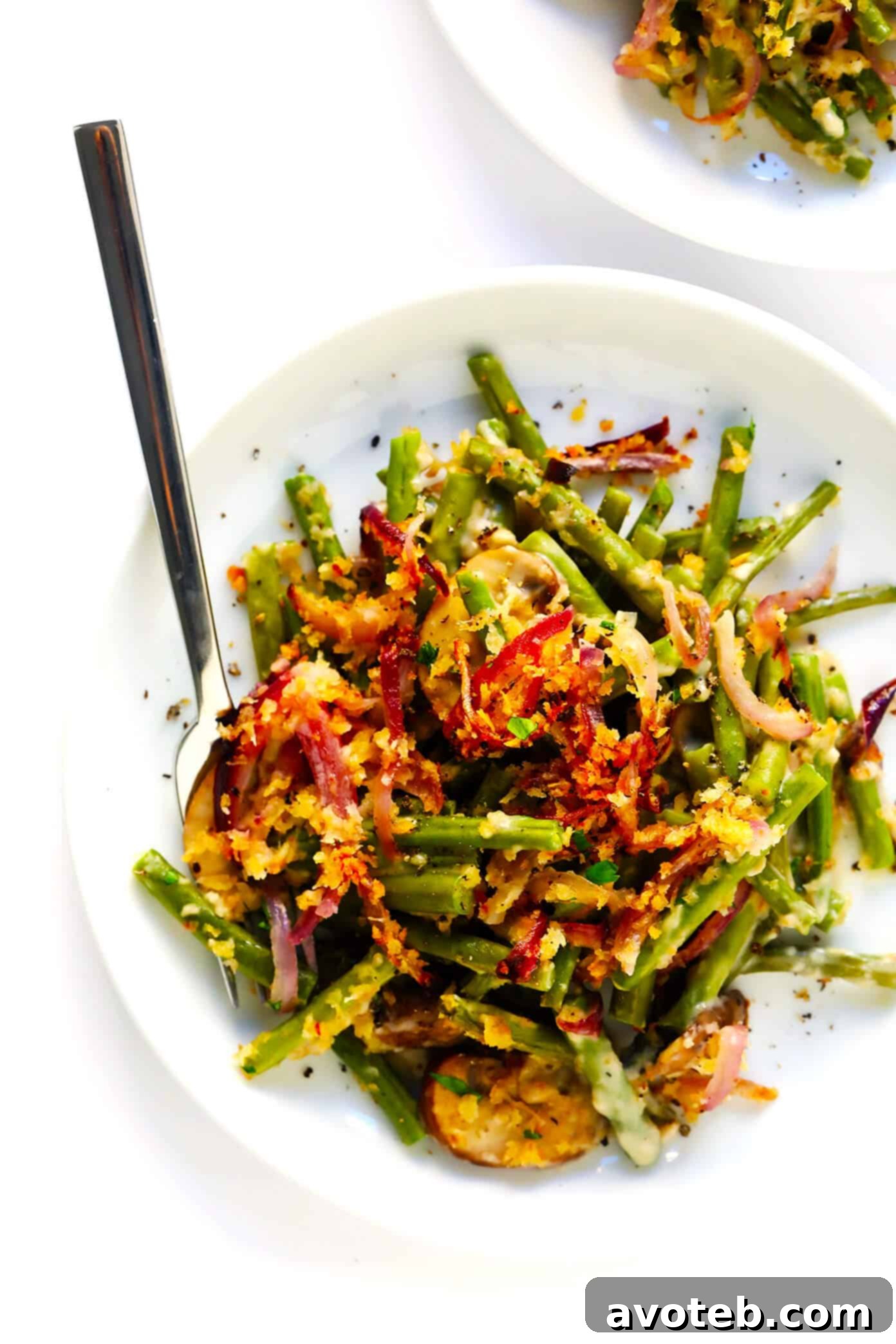 This BEST green bean casserole recipe -- made 100% from scratch with a crispy onion topping and creamy Parmesan mushroom green bean filling. So fresh and flavorful, and always the perfect side dish for Thanksgiving! | gimmesomeoven.com Best Green Bean Casserole Served on a Plate