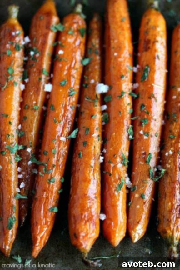 A vibrant serving of balsamic roasted baby carrots, glistening with a dark, rich glaze, perfectly tender and caramelized, presented in a rustic bowl.