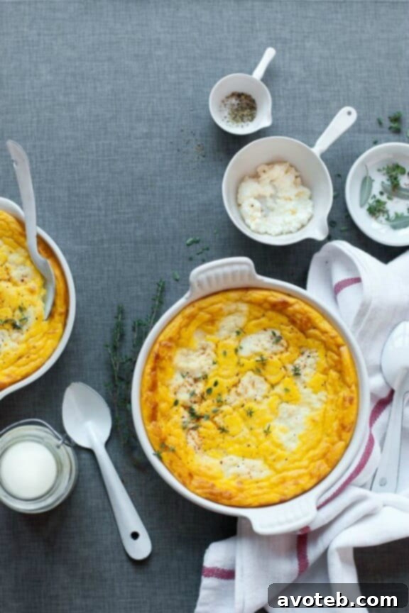 A warm, golden-brown Sweet Potato, Parsnip & Celeriac Pudding, baked in a rustic casserole dish and ready to be served, showcasing its smooth and creamy texture.