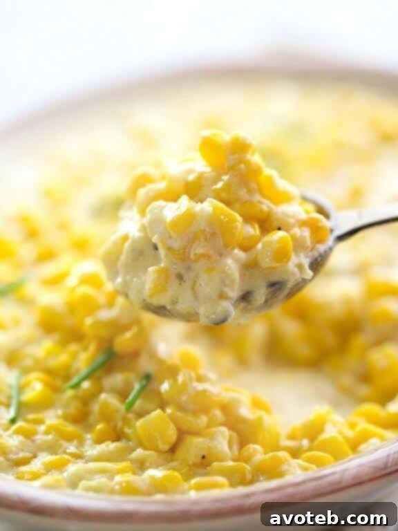 A rustic bowl of rich and creamy Slow Cooker Creamed Corn, showing its luscious texture and golden color, garnished with a sprig of fresh parsley.