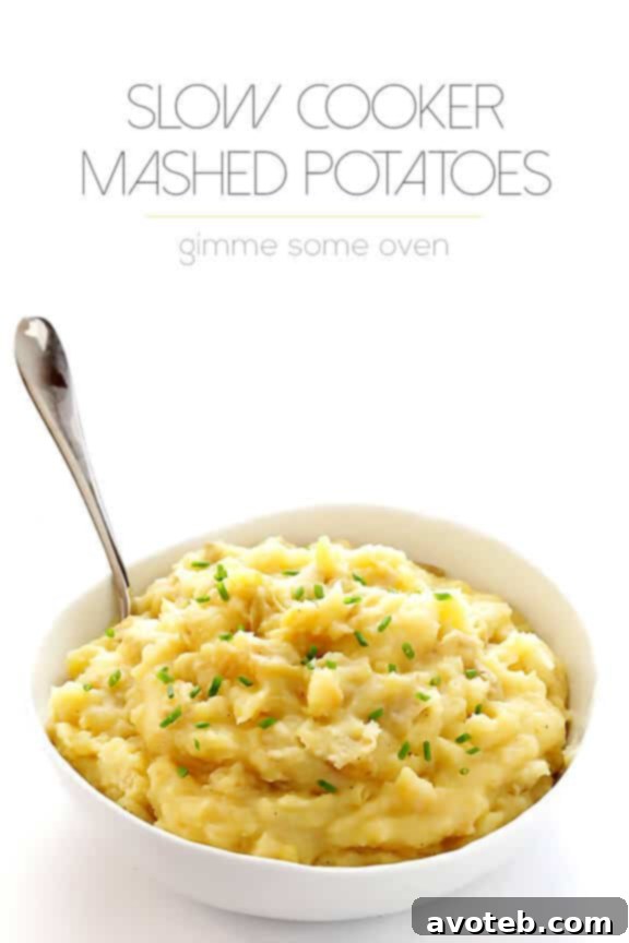 Overhead view of slow cooker mashed potatoes with a spoon, ready to be served.