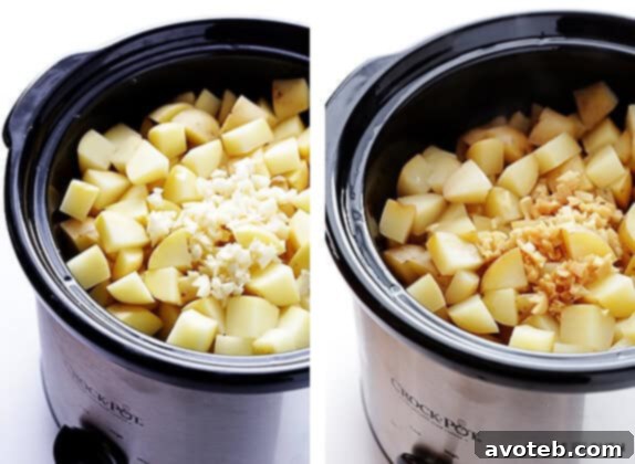 Potatoes, butter, broth, and garlic being added to a slow cooker for mashed potatoes.