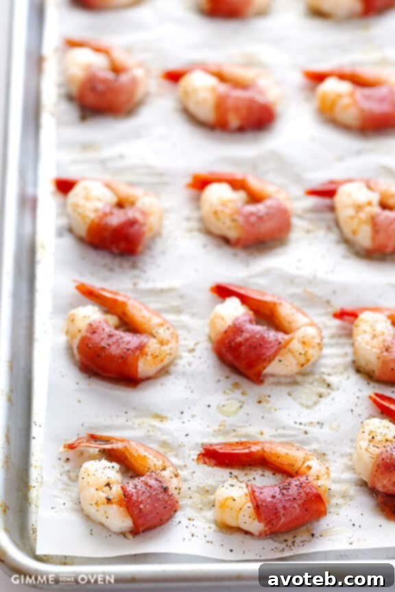 Effortless Prosciutto-Wrapped Prawns 6 Oven-baked prosciutto-wrapped shrimp arranged neatly on a baking sheet