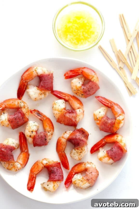 Effortless Prosciutto-Wrapped Prawns 7 Platter of finished prosciutto-wrapped shrimp with cocktail forks