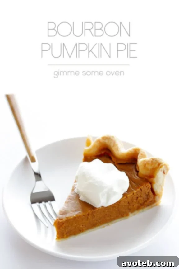 A whole Bourbon Pumpkin Pie decorated for Thanksgiving, ready to be sliced