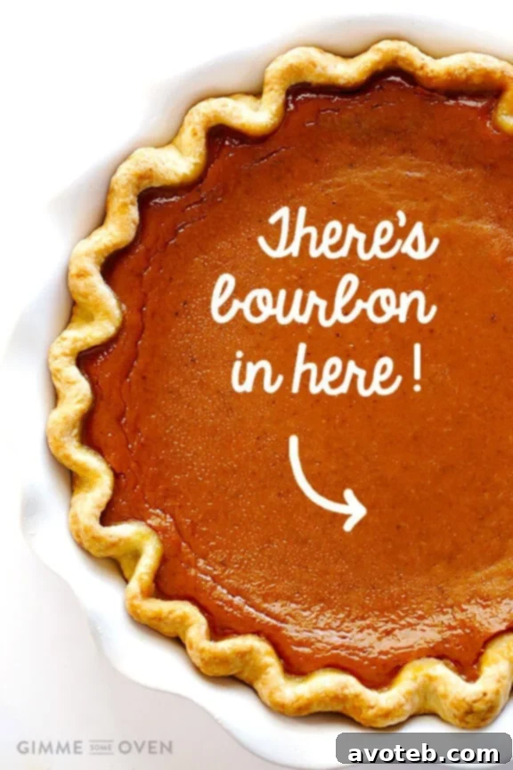 Close-up of a slice of Bourbon Pumpkin Pie with whipped cream