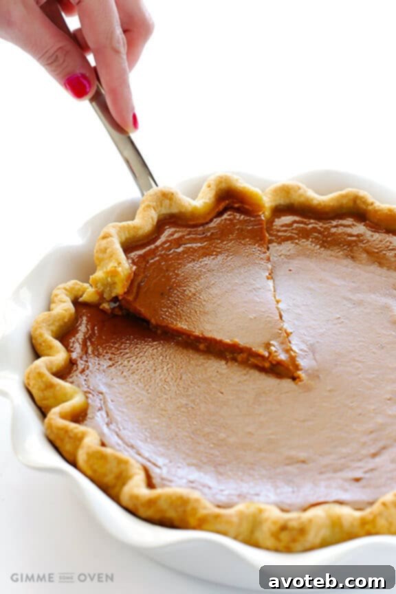 A slice of Bourbon Pumpkin Pie ready to be served