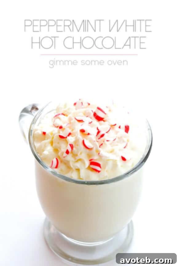 A top-down view of Peppermint White Hot Chocolate mugs, with festive decorations like pinecones and branches, evoking a holiday mood.