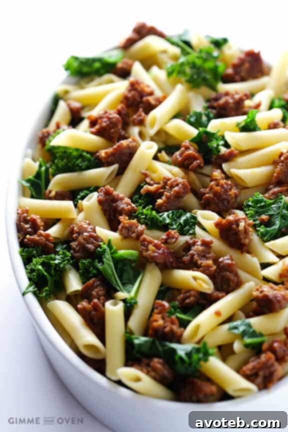 Ingredients for baked ziti laid out: Italian sausage, kale, garlic, ziti pasta, and mozzarella cheese.
