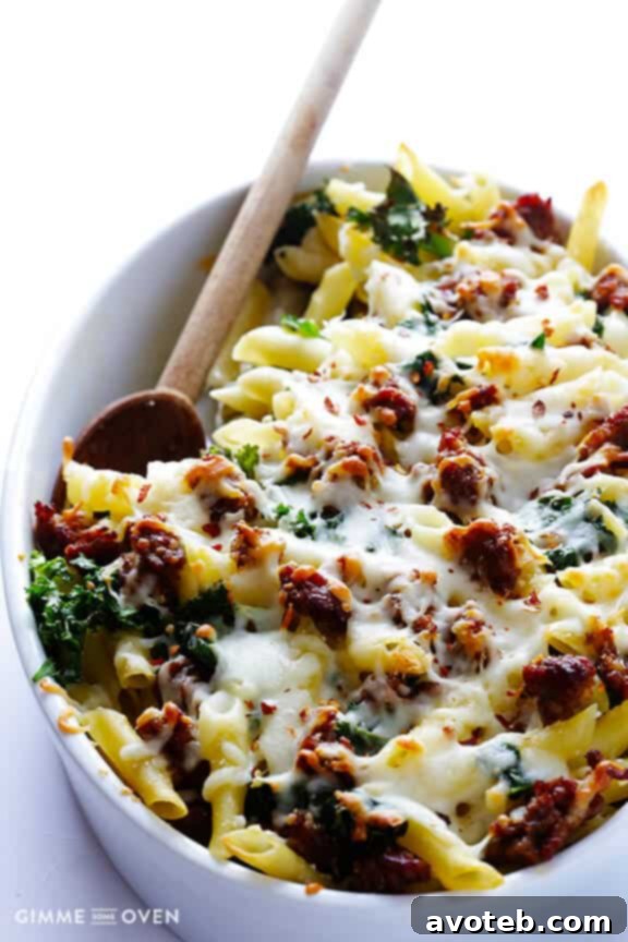 A serving of 5-Ingredient Italian Sausage and Kale Baked Ziti on a plate, showing melted cheese and pasta.