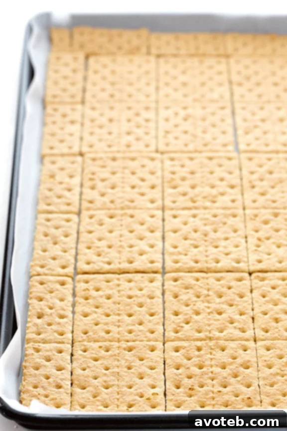 Graham crackers arranged on a baking sheet, ready for the toffee mixture
