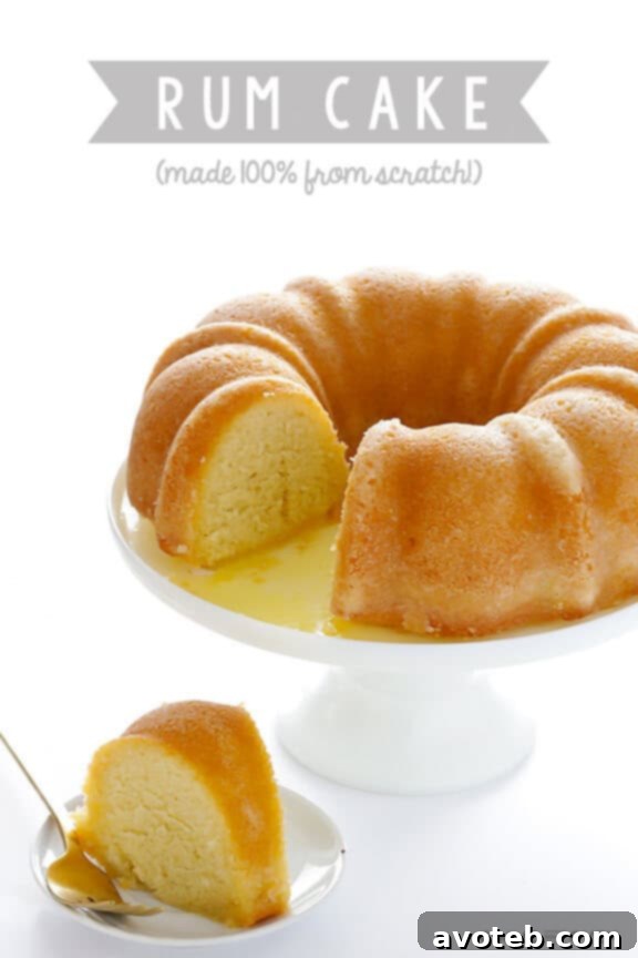 Handcrafted Rum Cake 11 A slice of homemade rum cake on a white plate with a fork