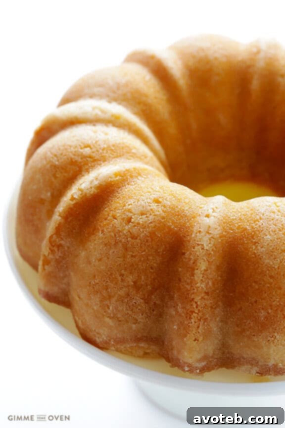 Handcrafted Rum Cake 7 Warm butter-rum sauce being poured over a freshly baked rum cake