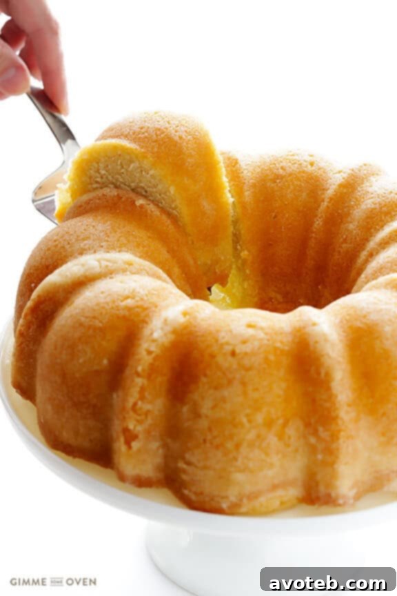 Handcrafted Rum Cake 9 Finished rum cake on a pedestal, glistening with butter-rum glaze