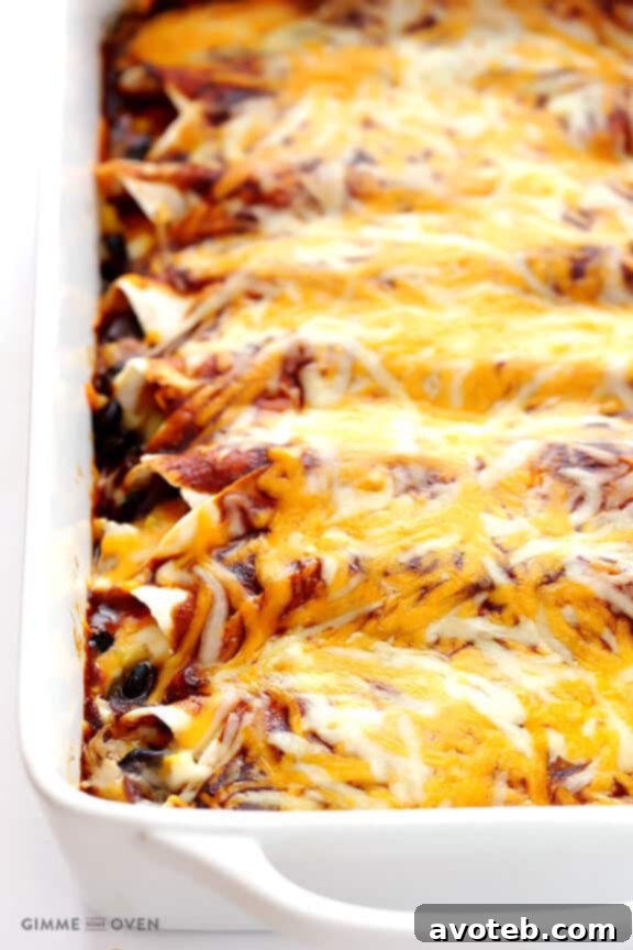 Close-up of a single BBQ Chicken Enchilada, highlighting the rich sauce and melted cheese.
