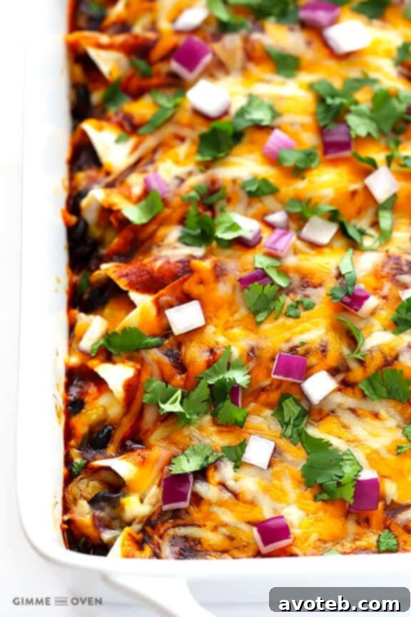 A baking dish filled with freshly baked BBQ Chicken Enchiladas, golden brown and bubbly.