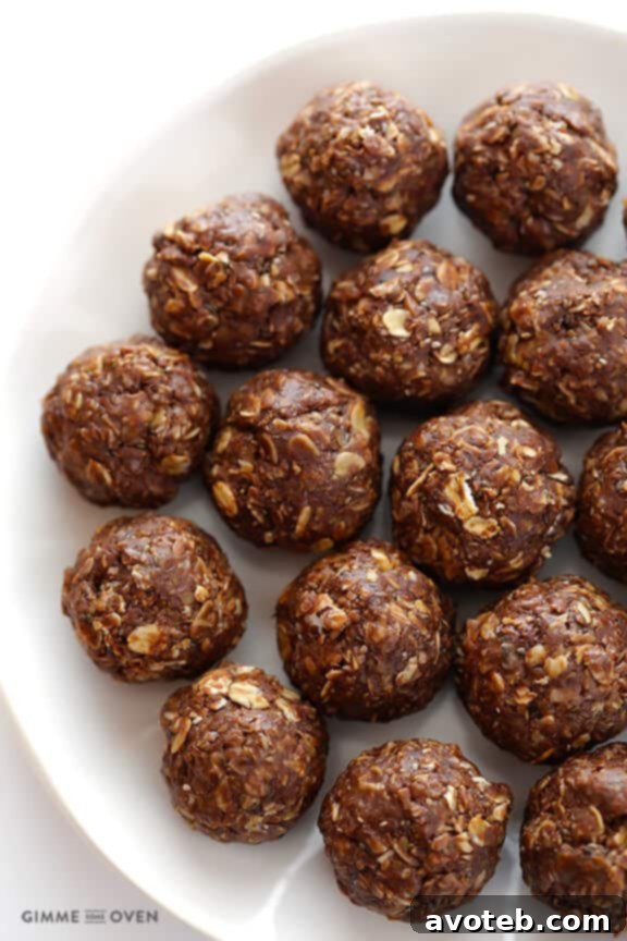 Rolling the chilled chocolate peanut butter energy bite mixture into 1-inch balls, yielding about 2 dozen delicious snacks. | gimmesomeoven.com