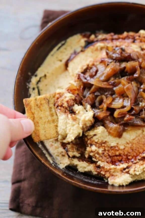 15 Recipes for Creamy Dreamy Hummus Bliss 11 A rustic bowl of gourmet Balsamic Caramelized Onion Hummus, generously topped with sweet, savory caramelized onions and a delicate drizzle of thick balsamic glaze. This sophisticated dip is perfect for entertaining.