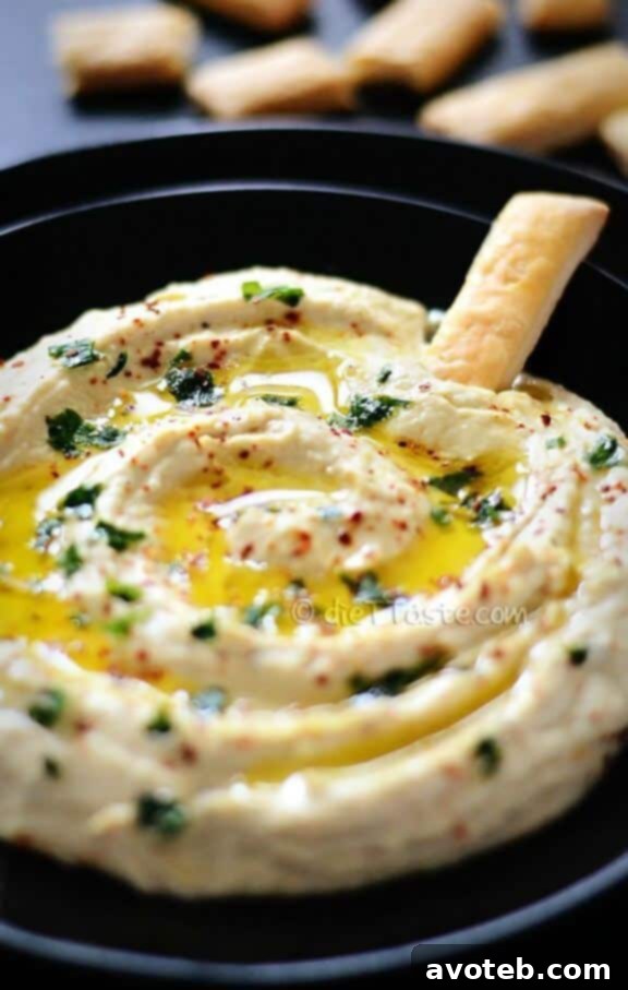 15 Recipes for Creamy Dreamy Hummus Bliss 12 A bowl of nutritious Hemp Seed Hummus, often garnished with whole hemp seeds and a touch of fresh herbs, emphasizing its health benefits and unique texture. This dip is a fantastic source of plant-based protein.