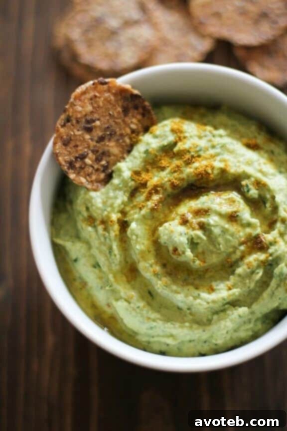 15 Recipes for Creamy Dreamy Hummus Bliss 5 A rich green Roasted Garlic Kale Hummus presented in a bowl, often topped with finely chopped kale, toasted seeds, and a delicate drizzle of olive oil. This superfood-packed dip offers both nutrition and deep flavor.
