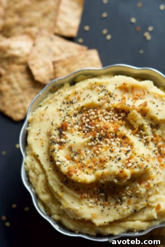 15 Recipes for Creamy Dreamy Hummus Bliss 6 A close-up of creamy Everything Bagel Hummus, generously sprinkled with the iconic everything bagel seasoning (sesame seeds, poppy seeds, dried garlic, dried onion, and salt). This unique hummus is a flavor explosion.