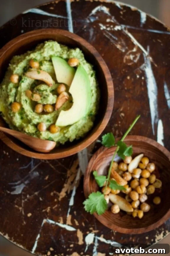 15 Recipes for Creamy Dreamy Hummus Bliss 9 A vibrant green Avocado Hummus, featuring an incredibly creamy texture and garnished with a delicate slice of fresh avocado and a sprinkle of chili flakes. This fusion dip combines the best of guacamole and hummus.