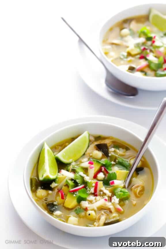 Close-up of a bowl of Easy Chicken Posole Verde with fresh garnishes.
