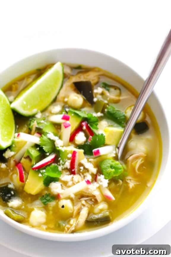 A close-up shot of a steaming bowl of Easy Chicken Posole Verde.