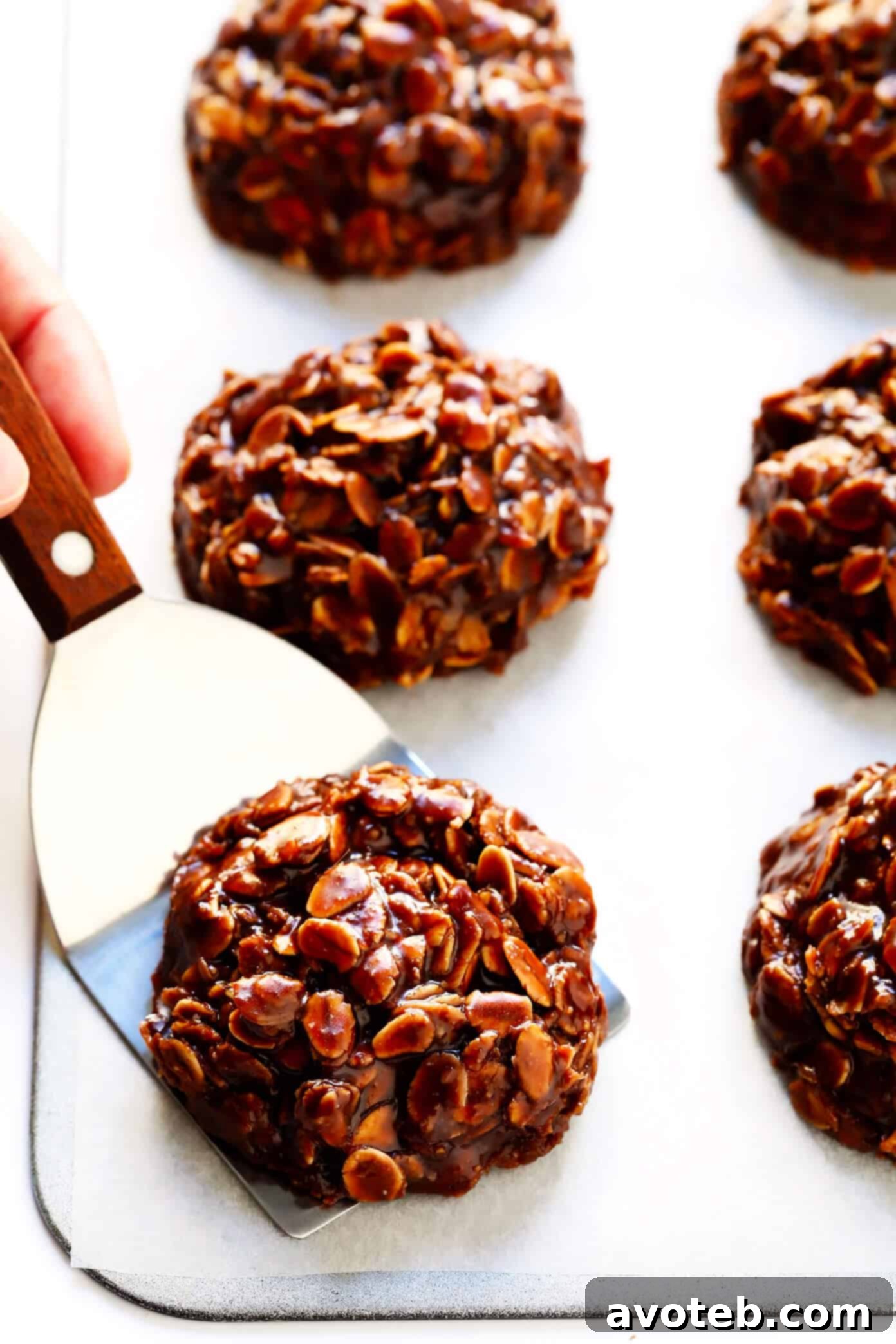 This classic No Bake Cookies recipe is easy to make in just 15 minutes, and that peanut butter + chocolate + oatmeal combination is always a winner! | Enjoy a plate of homemade no-bake chocolate peanut butter oatmeal cookies. #chocolate #nobake #cookies #peanutbutter #oatmeal #dessert Delicious Chocolate Peanut Butter No Bake Cookies
