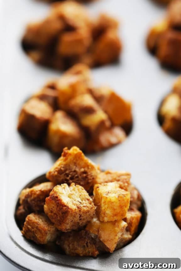 Tray of golden baked French Toast Cups fresh from the oven, showcasing their perfect muffin shape and crispy tops