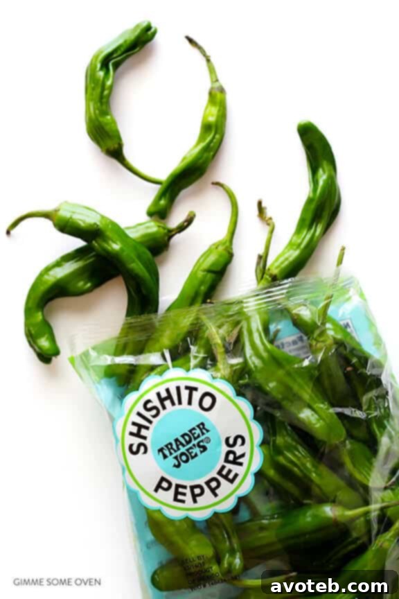 Toasted Sesame Shishito Bites 4 Shishito Peppers in a skillet, sizzling and starting to blister