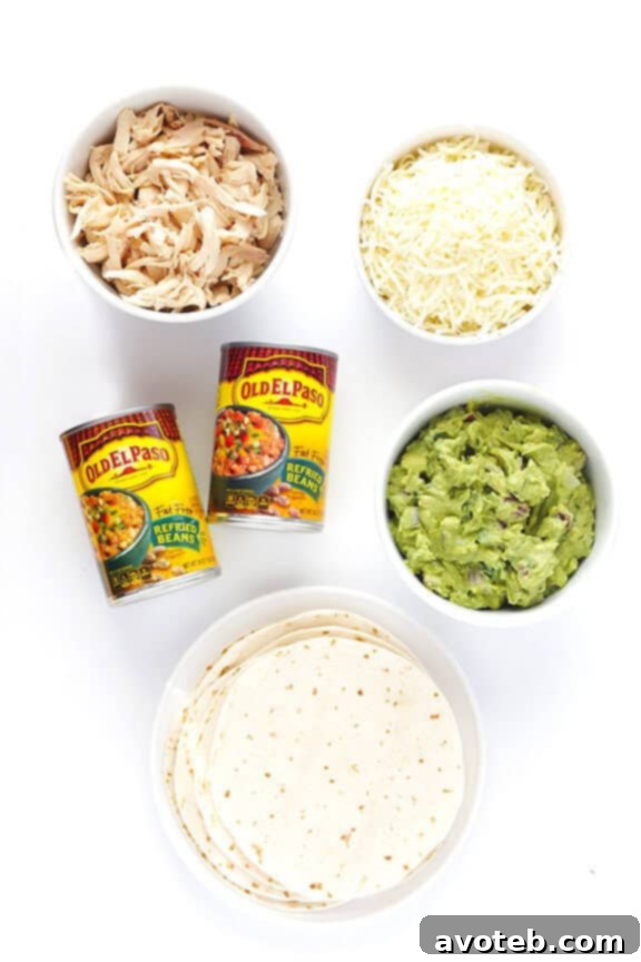 Close-up of freshly baked 5-Ingredient Chicken Guacamole Taquitos on a baking sheet