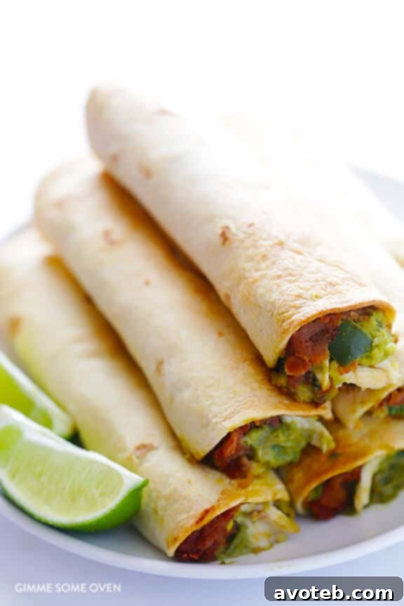 Freshly baked crispy 5-Ingredient Chicken Guacamole Taquitos on a baking sheet