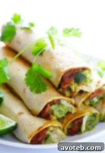 Stacked 5-Ingredient Chicken Guacamole Taquitos on a white plate