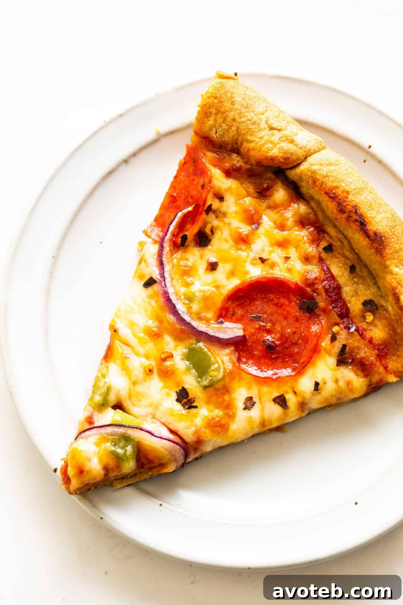 Slice of homemade pizza with whole wheat dough on a plate