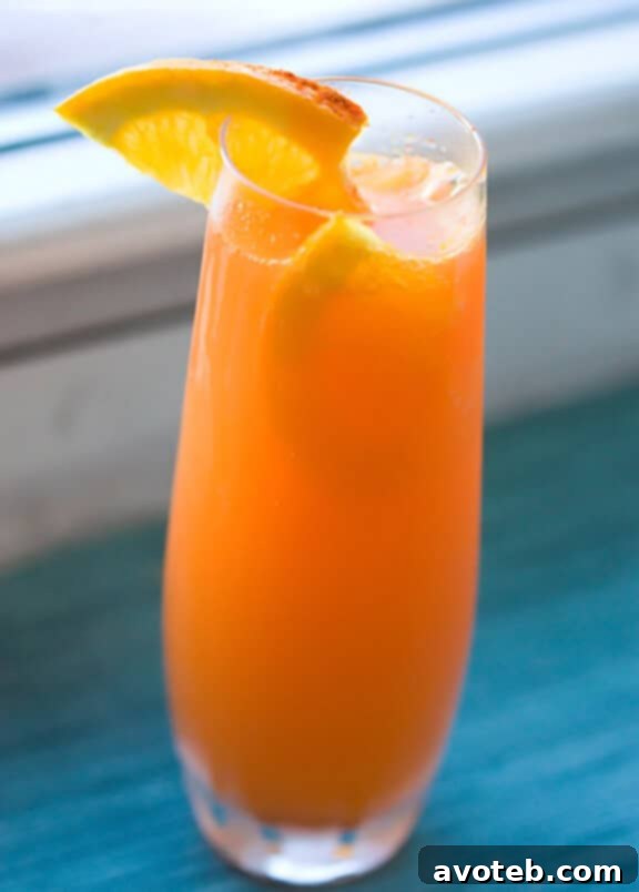 The Fizzy Bunny, a vibrant orange mimosa with carrot garnish.
