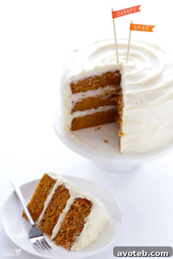 A slice of the Best Carrot Cake, with thick cream cheese frosting.