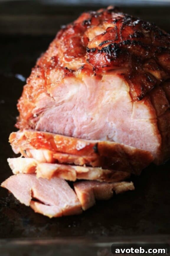 Slow Cooker Ham with Maple Brown Sugar Glaze, perfectly cooked and glistening.