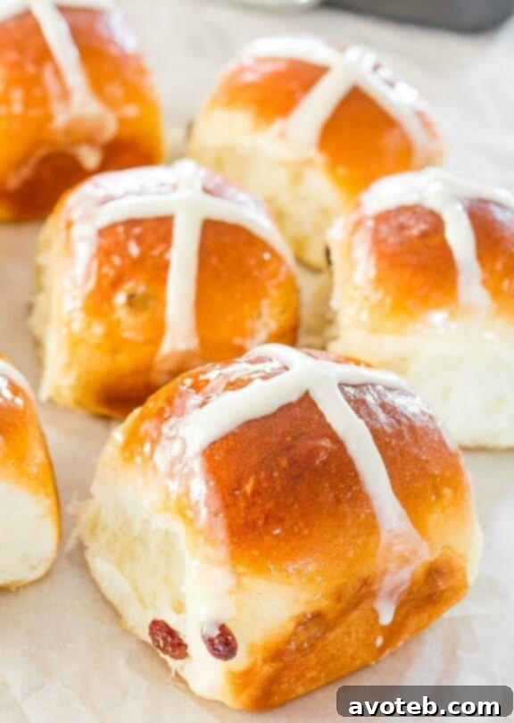 Freshly baked Hot Crossed Buns, topped with white icing cross.