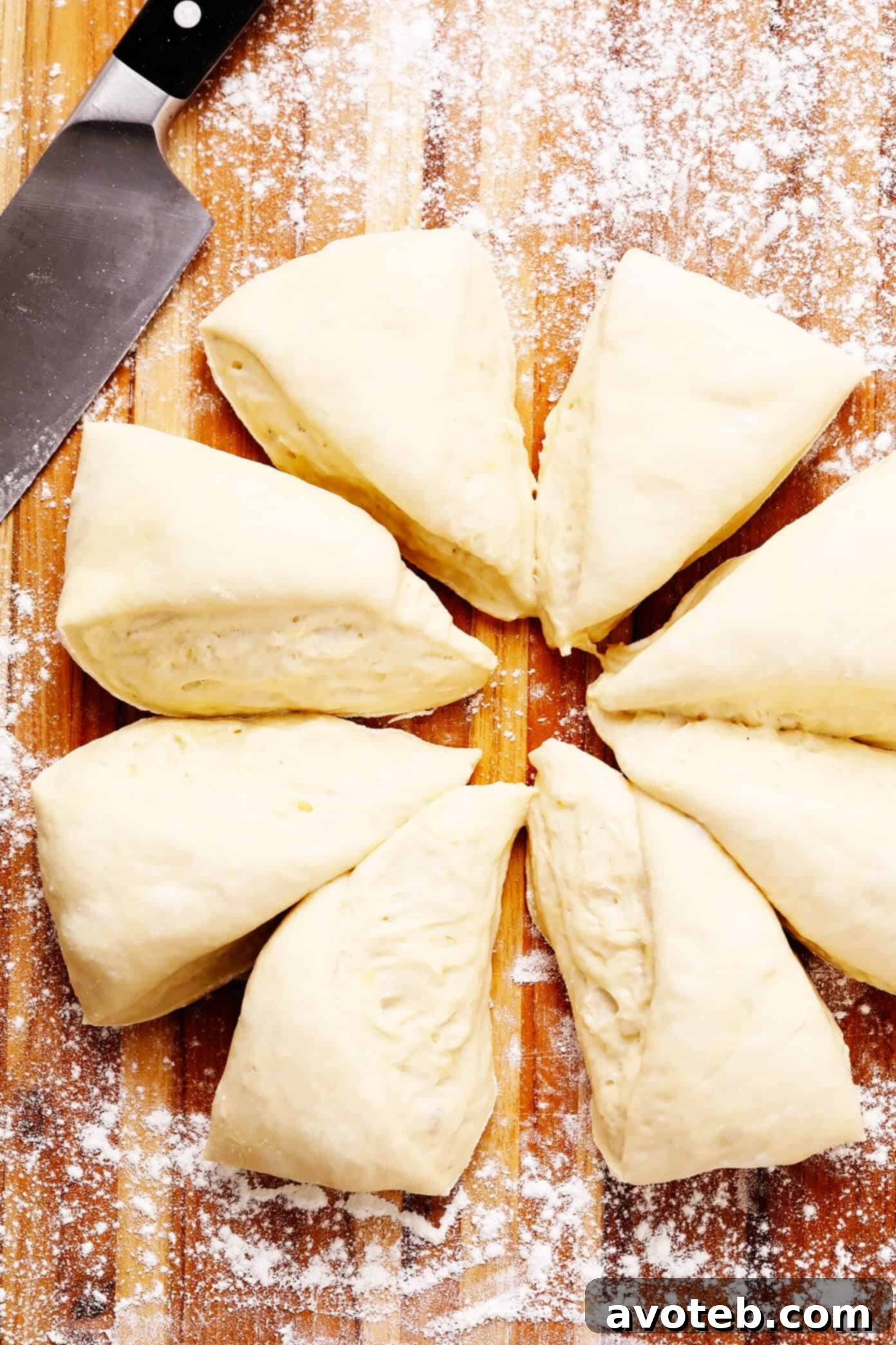 Achieving perfectly shaped naan starts with properly dividing the dough. Learn how to prepare your homemade naan dough and cut it into even wedges for optimal results. #naandough #bakingtips #homemadebread Homemade Naan Dough Prepared and Divided into Wedges