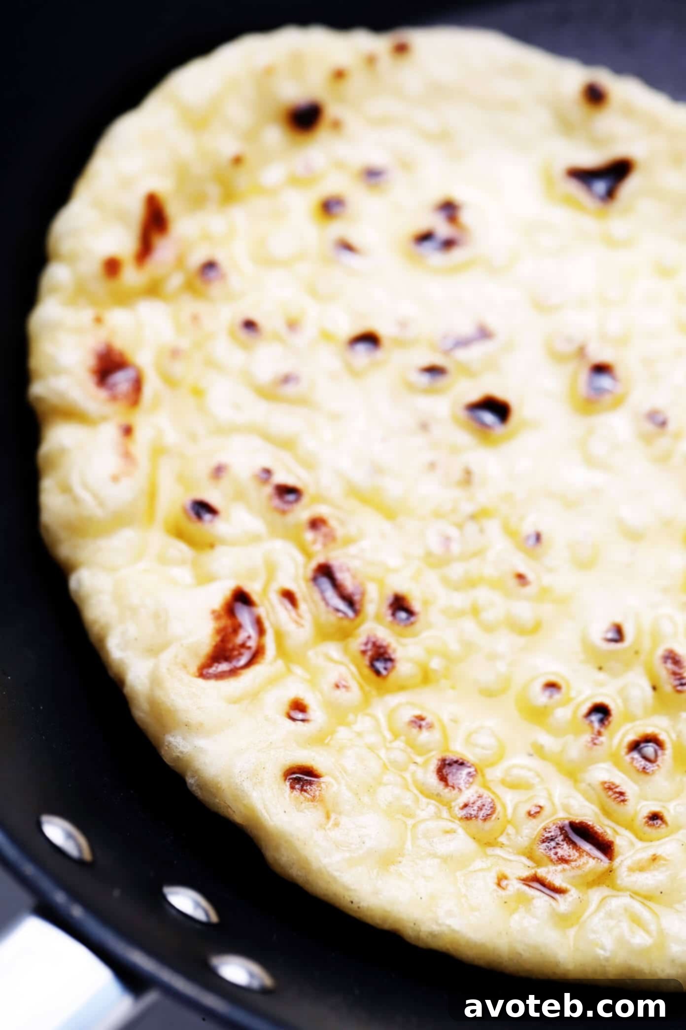Indulge in the savory delight of homemade garlic naan. Learn how to make the perfect garlic butter to brush over your warm, freshly cooked flatbread. #garlicnaan #butter #homemadefood #tastybread Homemade Naan with Irresistible Garlic Butter Glaze