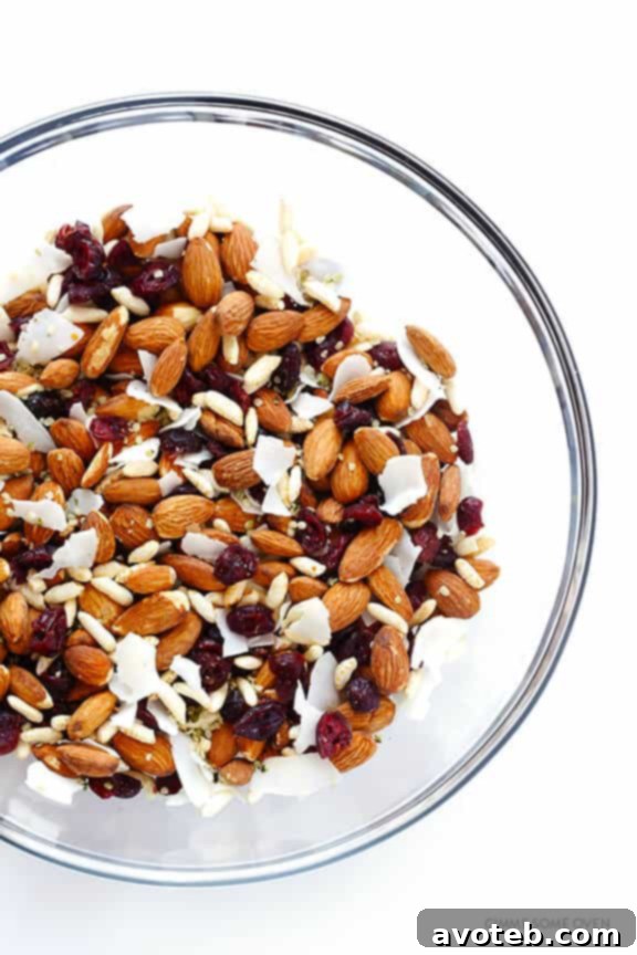 Close-up of freshly prepared Cranberry Almond Protein Bars before cutting, showcasing the vibrant mix of nuts and fruit.
