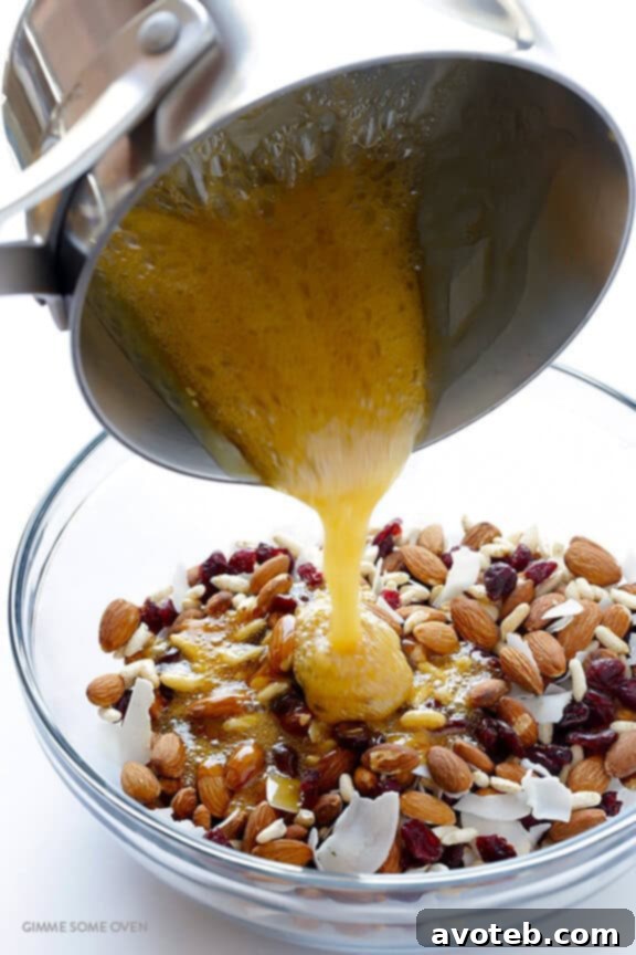 The dry ingredients for Cranberry Almond Protein Bars, including Blue Diamond almonds, dried cranberries, puffed rice, coconut, and hemp seeds, mixed in a bowl.