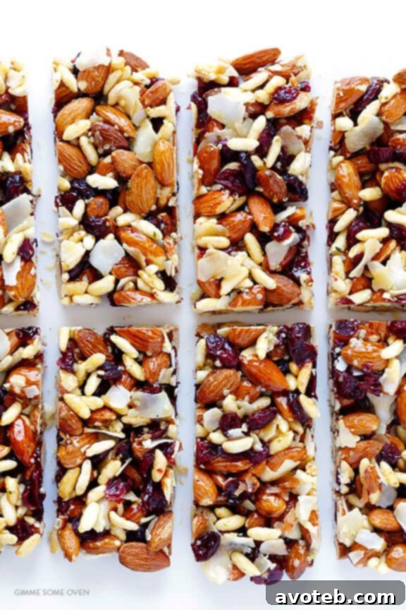 The Cranberry Almond Protein Bars setting in a parchment-lined baking dish, allowing them to cool and firm up.