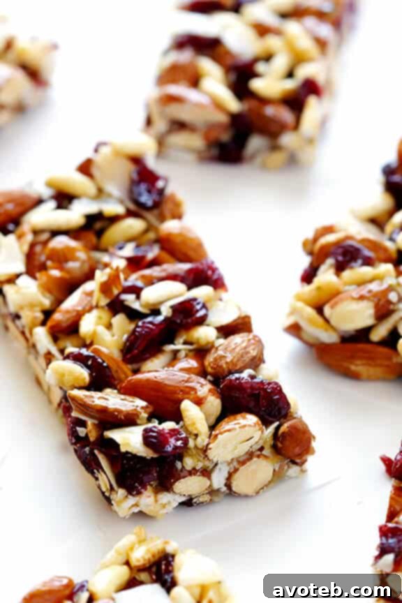 A single Cranberry Almond Protein Bar with a bite taken out, clearly showing the texture and the wholesome ingredients within.