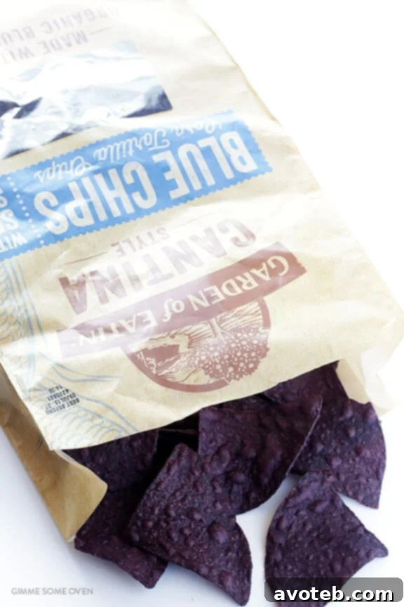 Crispy blue corn tortilla chips topped with melted Monterrey Jack cheese, forming the perfect base for loaded nachos.